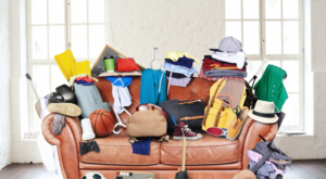 A couch in a room that is full of clutter of junk